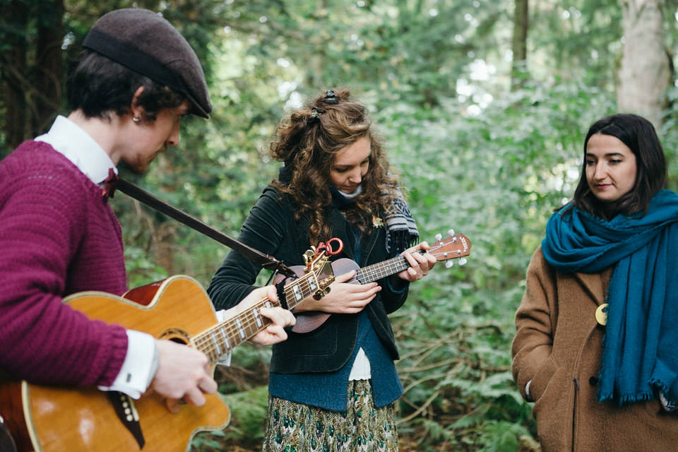 A tweed jacket and feathers in her hair for a boho bride and her eclectic woodland wedding. Images by Mirrorbox Photography.