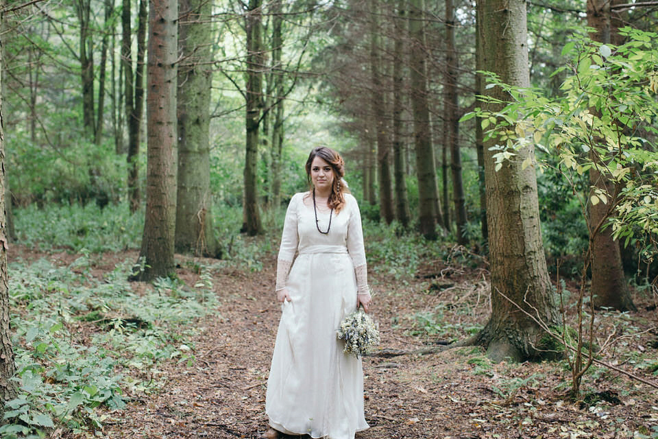 A tweed jacket and feathers in her hair for a boho bride and her eclectic woodland wedding. Images by Mirrorbox Photography.