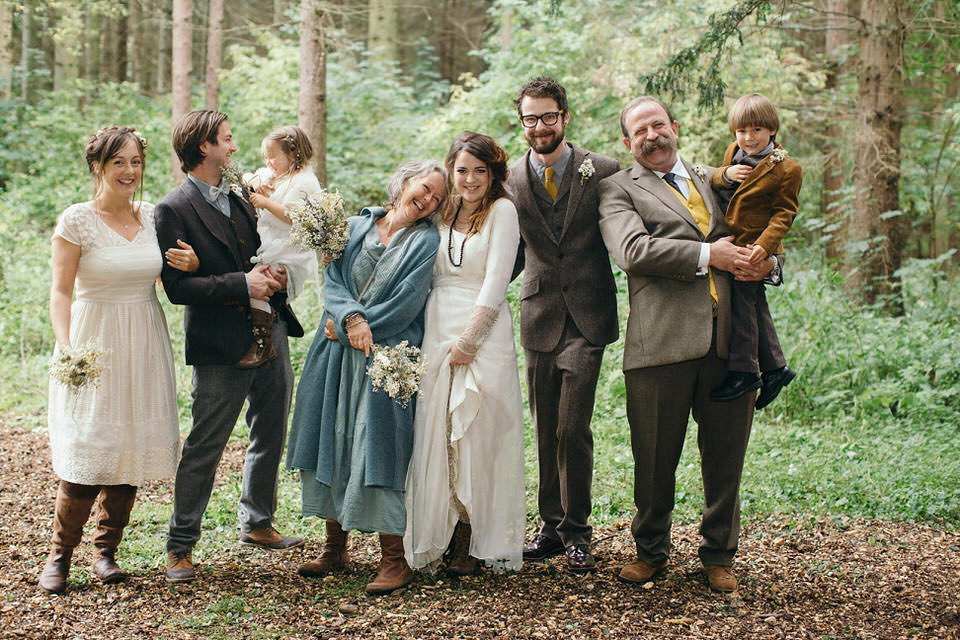 A tweed jacket and feathers in her hair for a boho bride and her eclectic woodland wedding. Images by Mirrorbox Photography.