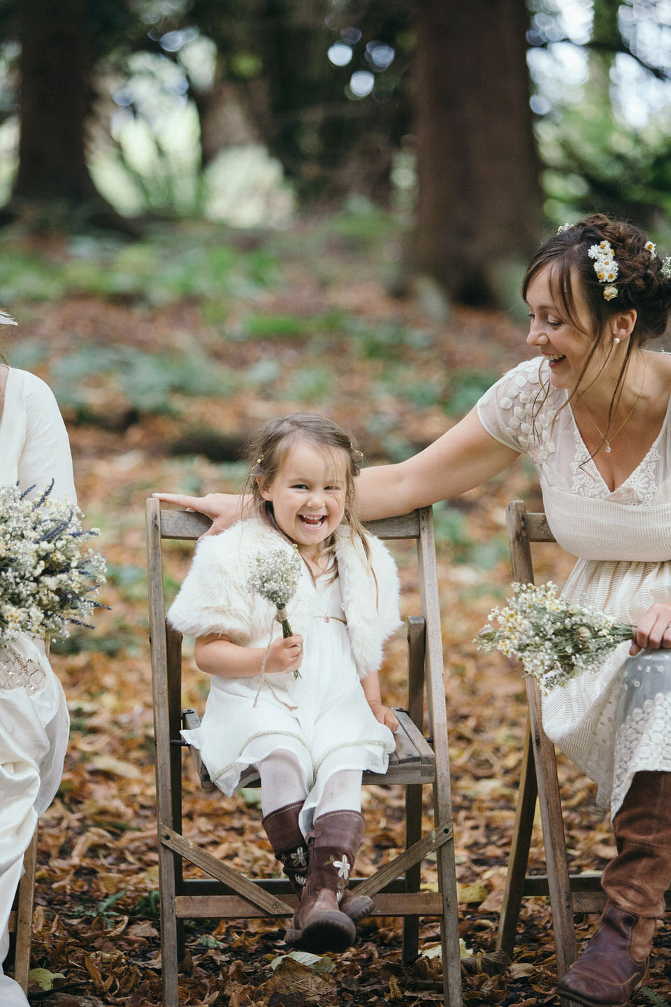 A tweed jacket and feathers in her hair for a boho bride and her eclectic woodland wedding. Images by Mirrorbox Photography.