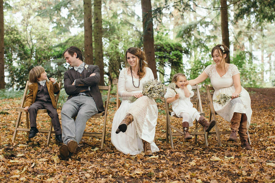 A tweed jacket and feathers in her hair for a boho bride and her eclectic woodland wedding. Images by Mirrorbox Photography.