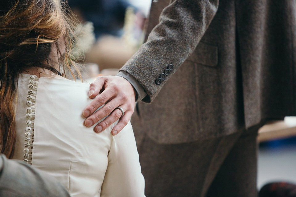 A tweed jacket and feathers in her hair for a boho bride and her eclectic woodland wedding. Images by Mirrorbox Photography.