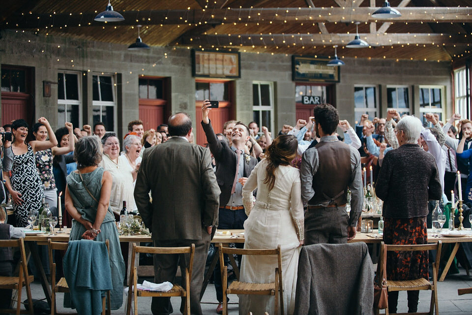 A tweed jacket and feathers in her hair for a boho bride and her eclectic woodland wedding. Images by Mirrorbox Photography.