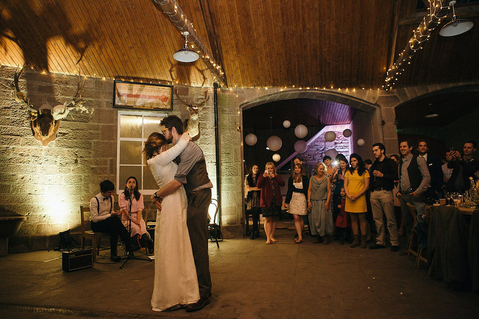 A tweed jacket and feathers in her hair for a boho bride and her eclectic woodland wedding. Images by Mirrorbox Photography.