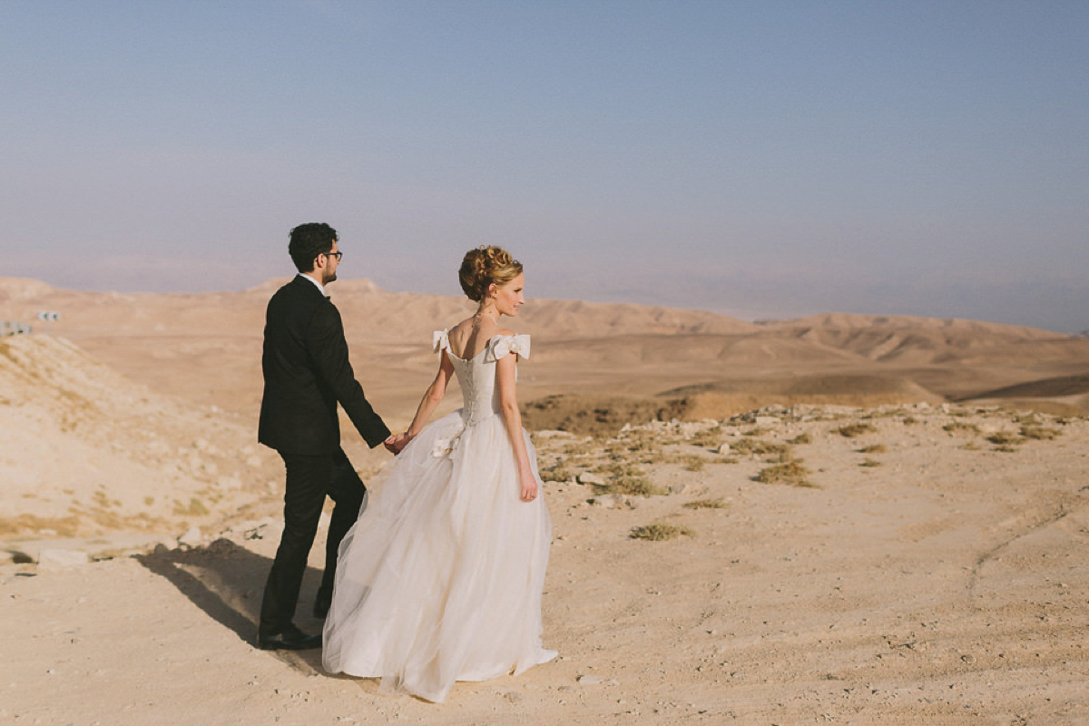 Bride Noga wore a vintage wedding dress for her modern festival wedding in the desert. Images by Echoes & Wildhearts Photography.