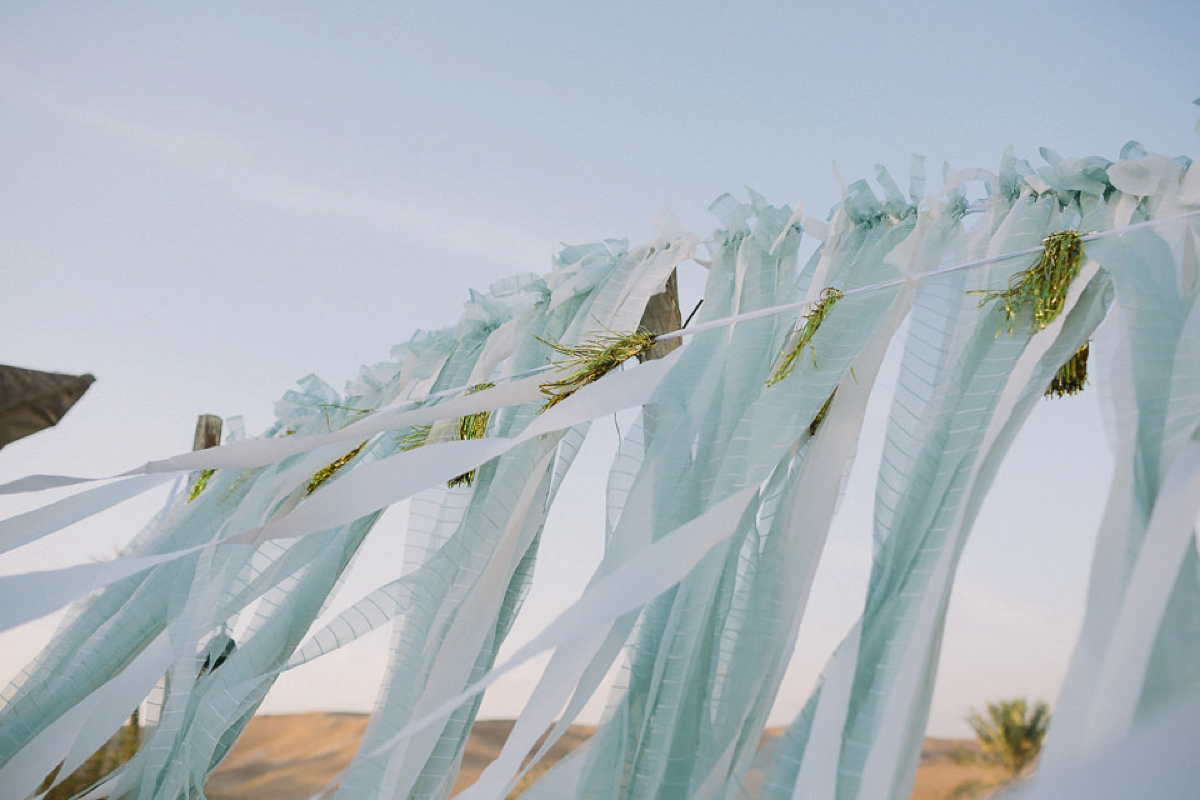 Bride Noga wore a vintage wedding dress for her modern festival wedding in the desert. Images by Echoes & Wildhearts Photography.