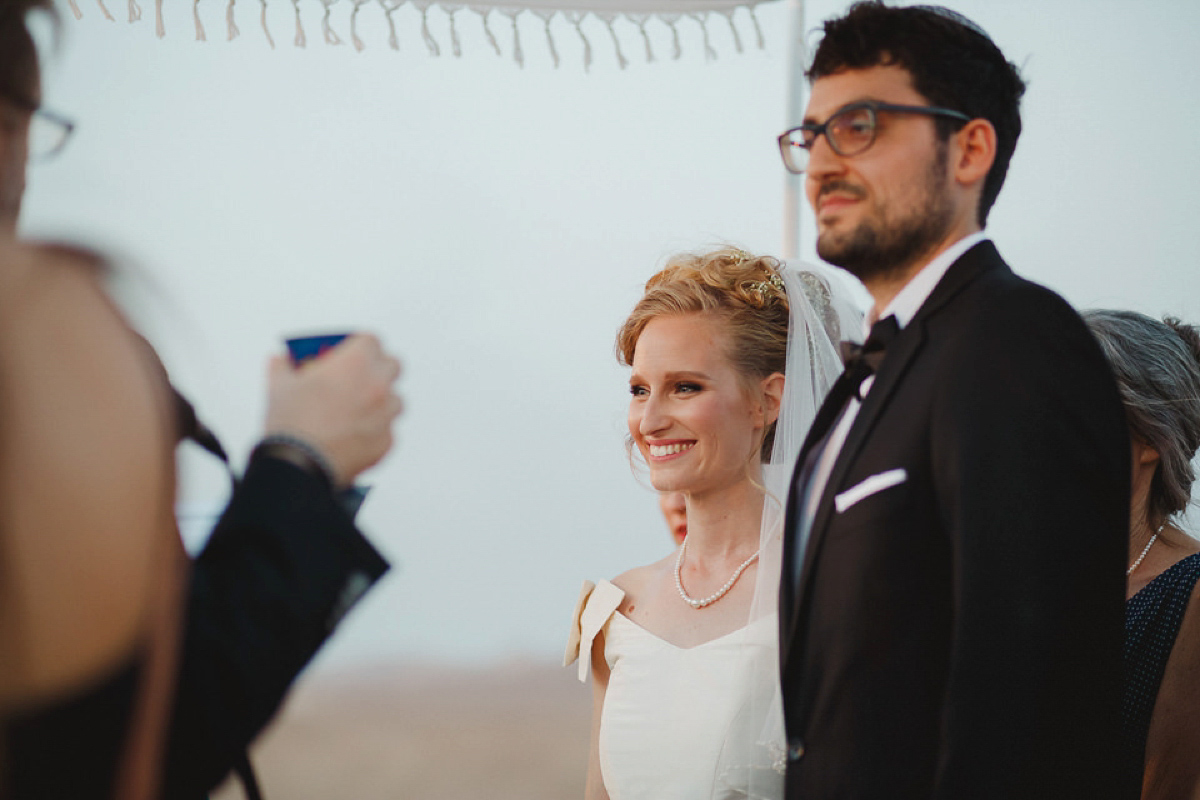 Bride Noga wore a vintage wedding dress for her modern festival wedding in the desert. Images by Echoes & Wildhearts Photography.