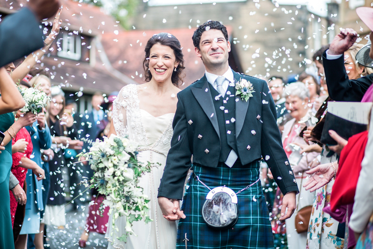 The bride wore a Catherine Deane gown for her Autumn wedding in Edinburgh. Photography by Carley Buick.