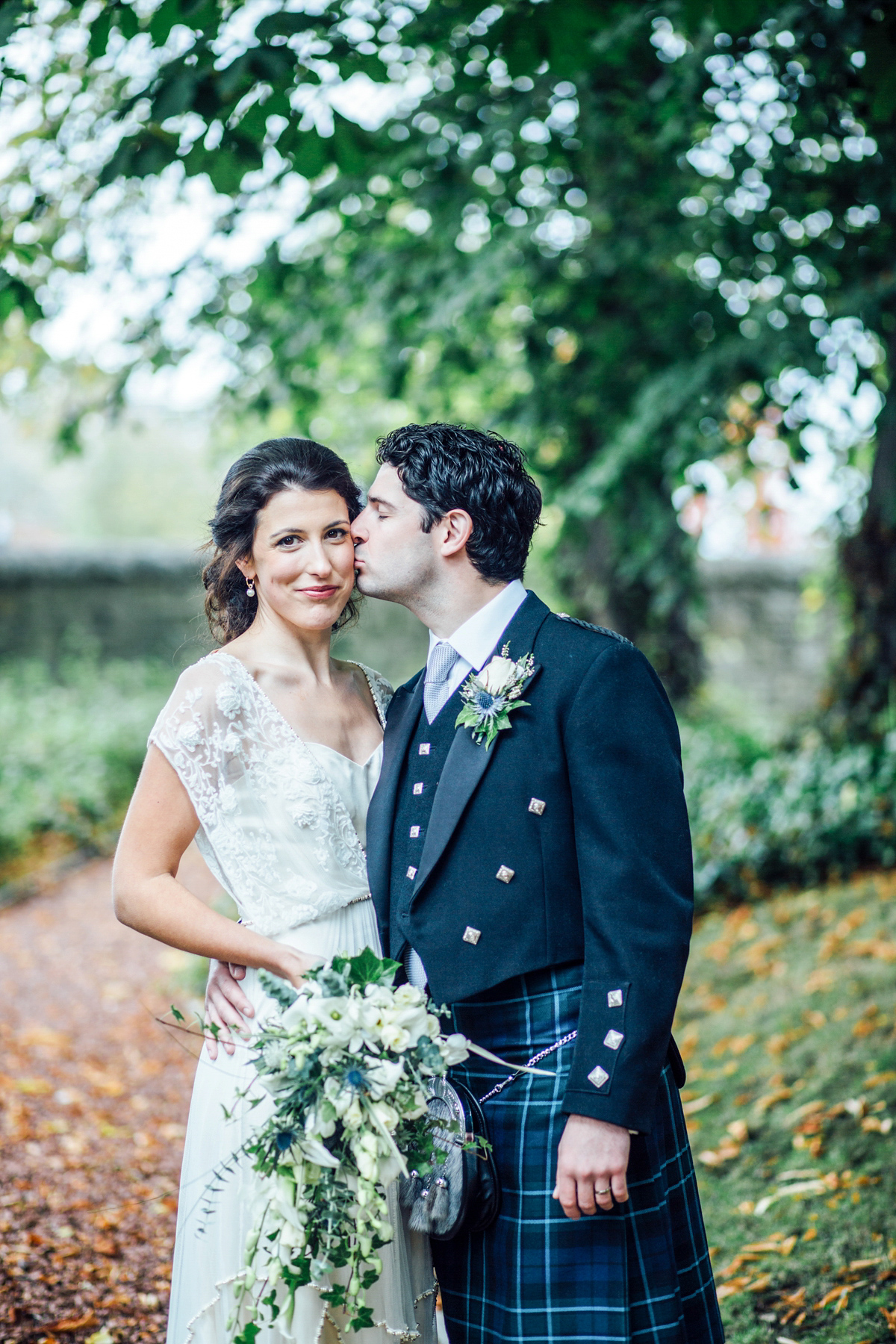 The bride wore a Catherine Deane gown for her Autumn wedding in Edinburgh. Photography by Carley Buick.