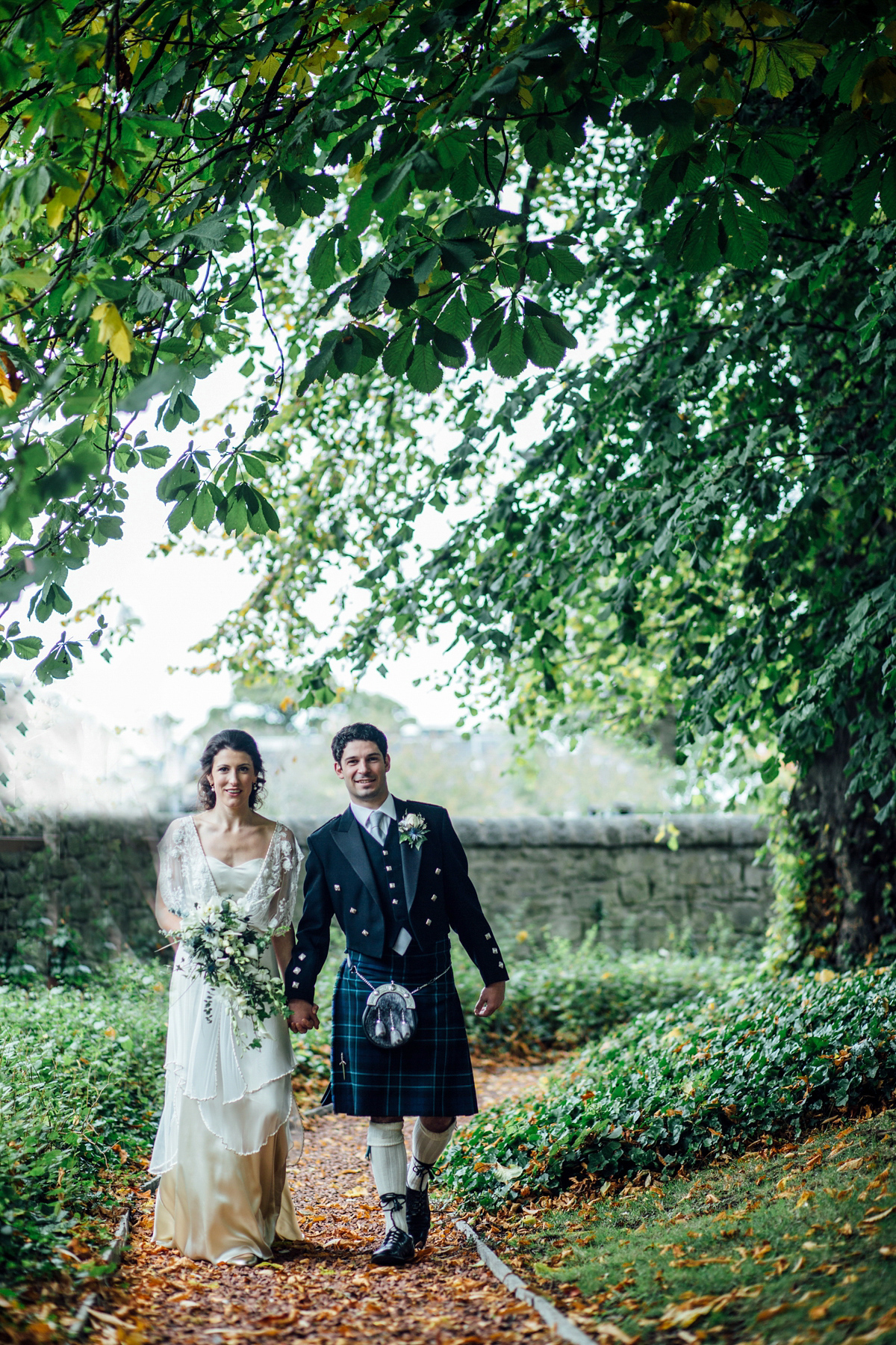 The bride wore a Catherine Deane gown for her Autumn wedding in Edinburgh. Photography by Carley Buick.