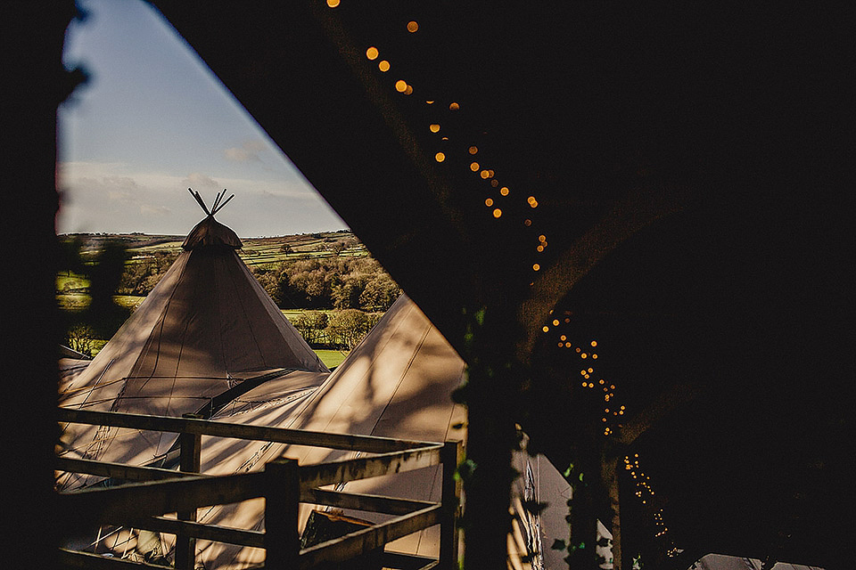 Bride Olivia wore a Charlie Brear gown for her Papakata teepee wedding on New Years Eve. The coupled tied the knot in the bride's mothers garden. Photography by Steve Rooney.