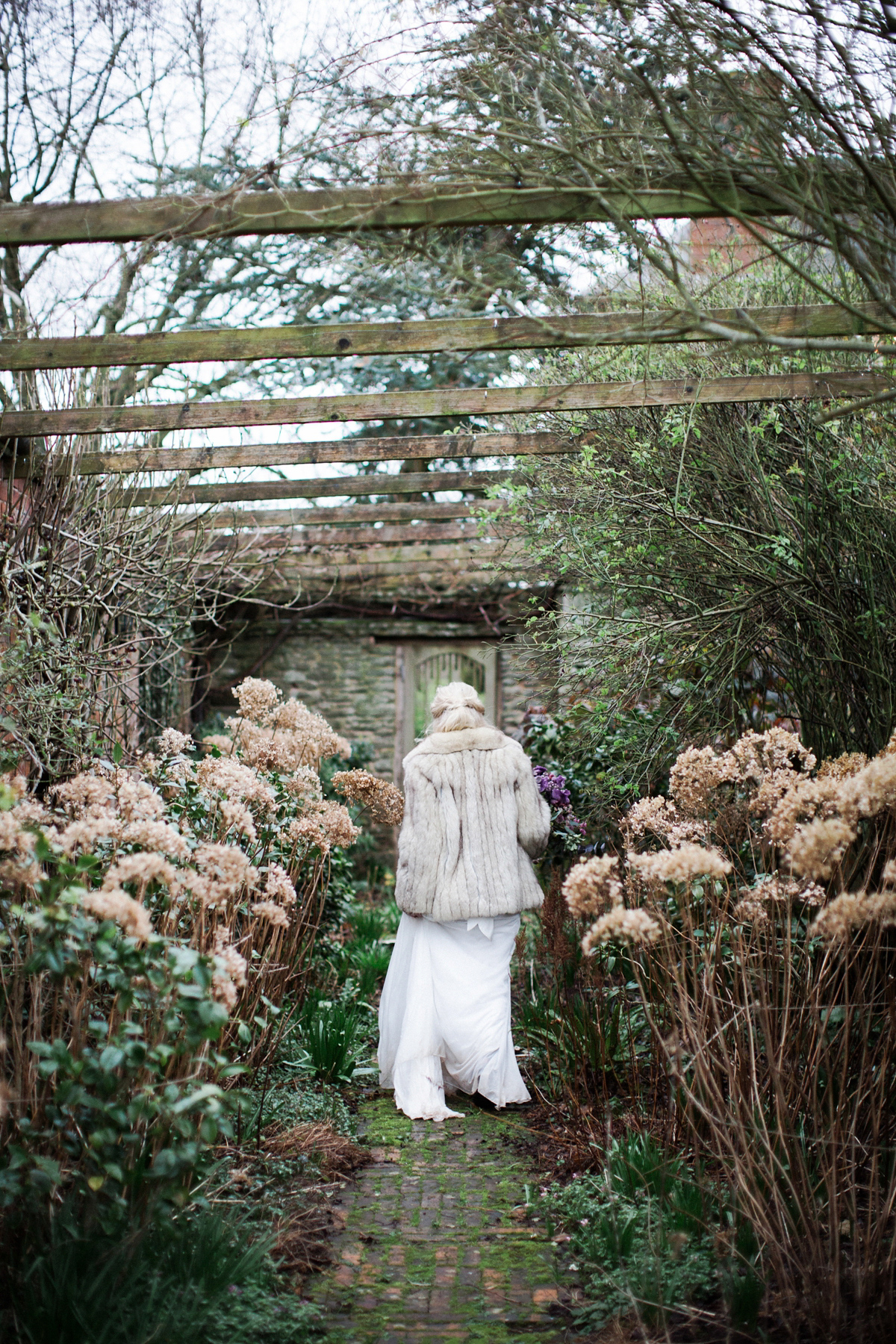The bride wears Anna Campbell for her winter wedding at Dewsall Court. Fine Art wedding photography by Melissa Beattie.