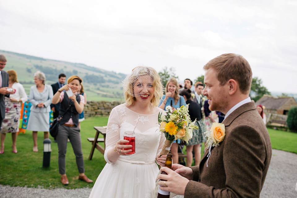 Sarah wears a 1950's inspired dress for her rustic wedding at Danby Castle in North Yorkshire. Photography by Stott & Atkinson.