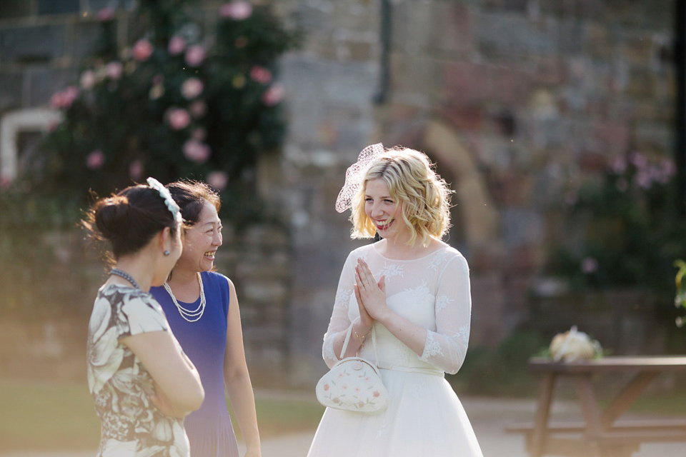 Sarah wears a 1950's inspired dress for her rustic wedding at Danby Castle in North Yorkshire. Photography by Stott & Atkinson.