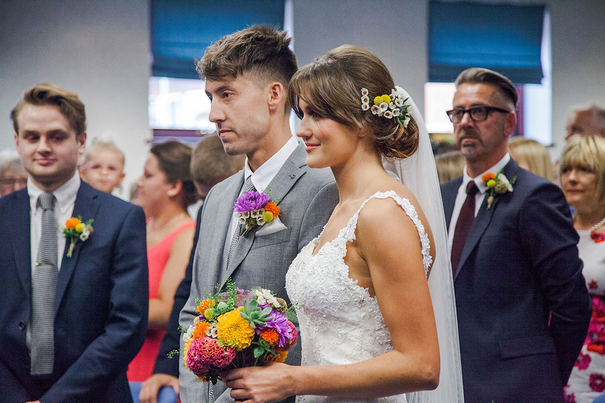 Abigail wore a backless Pronovias gown for her colourful Summer wedding at Shustoke Barn. Photogrpahy by Ria Beth.