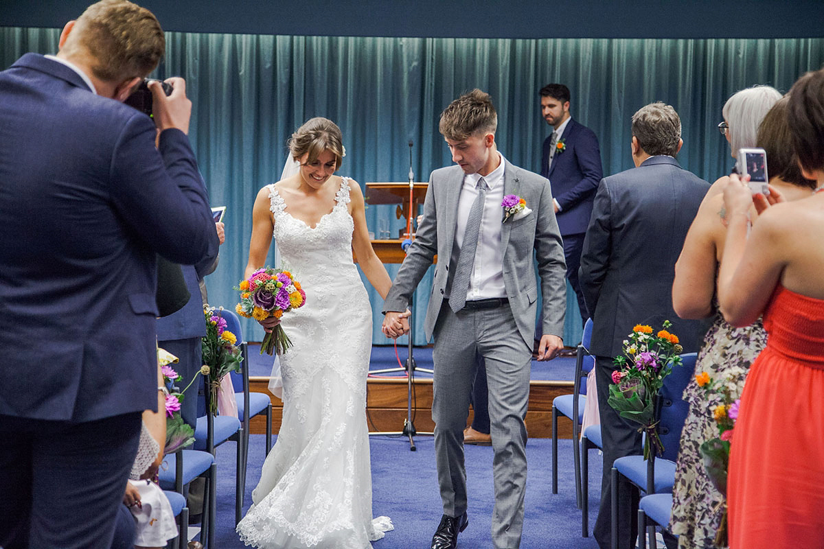 Abigail wore a backless Pronovias gown for her colourful Summer wedding at Shustoke Barn. Photogrpahy by Ria Beth.