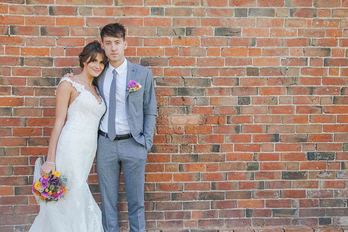 Abigail wore a backless Pronovias gown for her colourful Summer wedding at Shustoke Barn. Photogrpahy by Ria Beth.