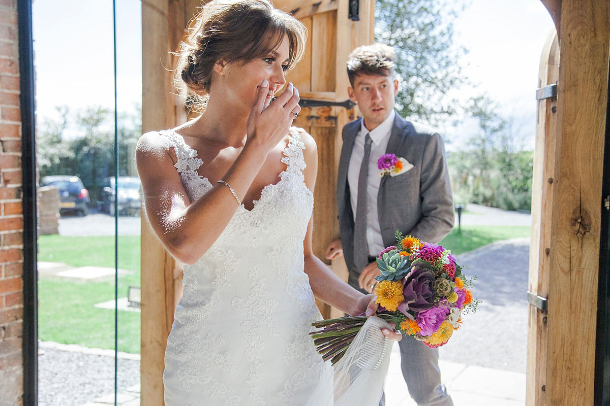 Abigail wore a backless Pronovias gown for her colourful Summer wedding at Shustoke Barn. Photogrpahy by Ria Beth.