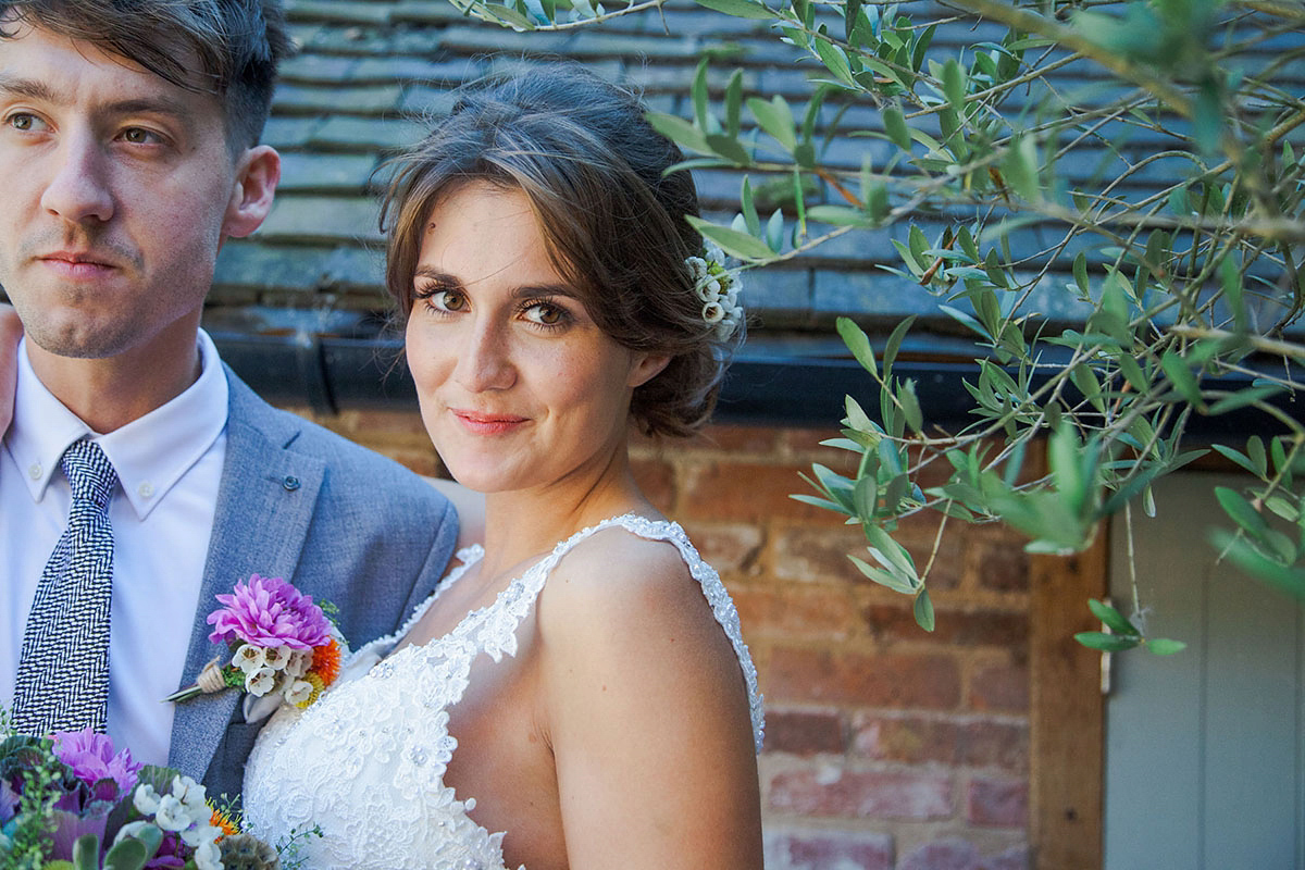 Abigail wore a backless Pronovias gown for her colourful Summer wedding at Shustoke Barn. Photogrpahy by Ria Beth.