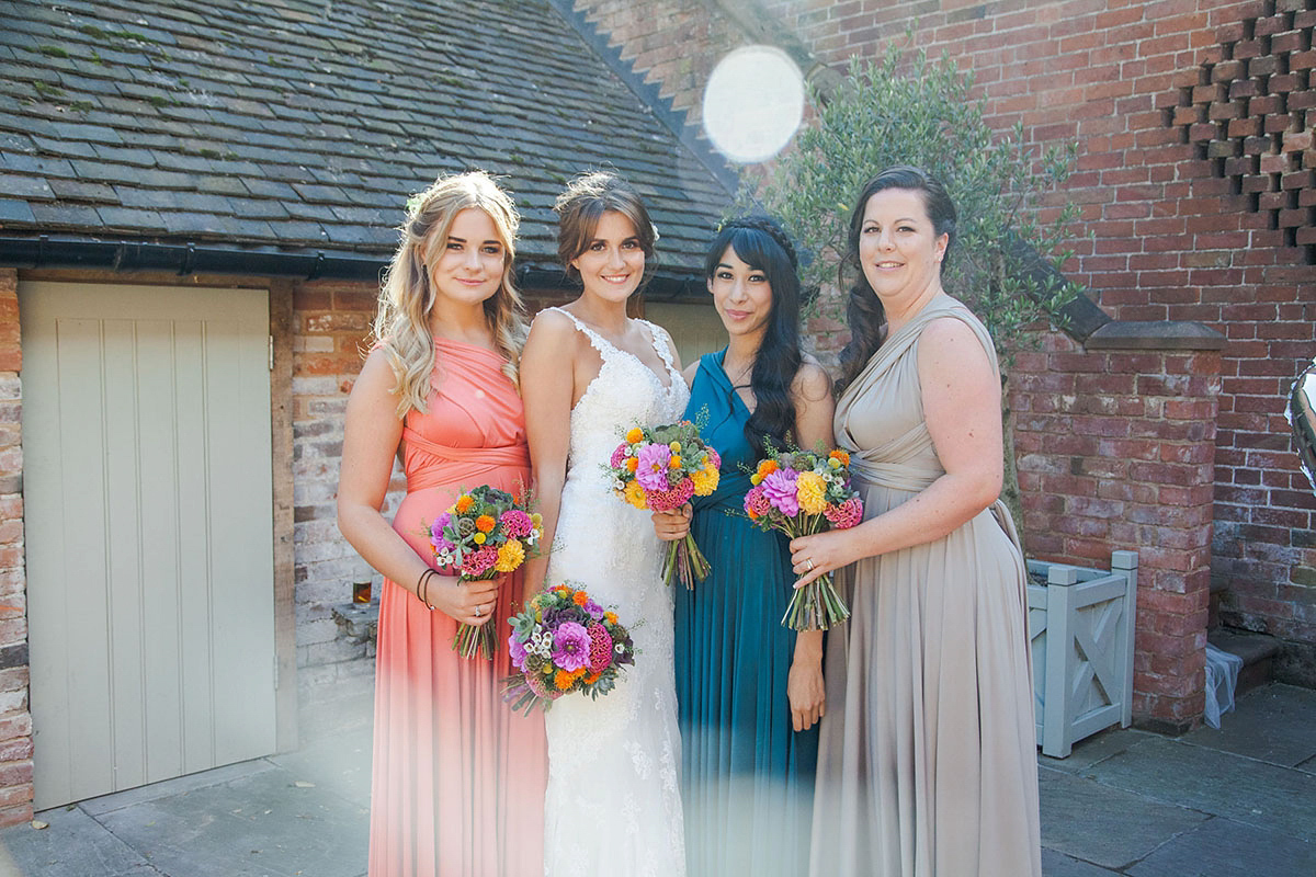 Abigail wore a backless Pronovias gown for her colourful Summer wedding at Shustoke Barn. Photogrpahy by Ria Beth.