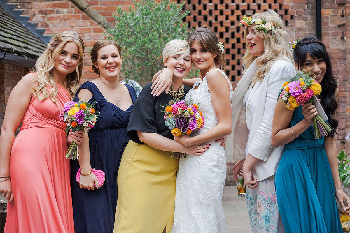 Abigail wore a backless Pronovias gown for her colourful Summer wedding at Shustoke Barn. Photogrpahy by Ria Beth.