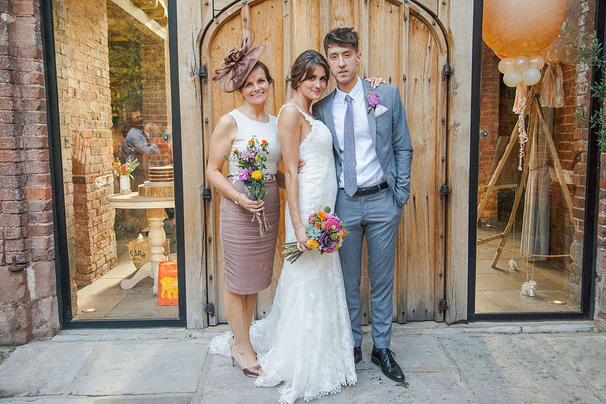 Abigail wore a backless Pronovias gown for her colourful Summer wedding at Shustoke Barn. Photogrpahy by Ria Beth.