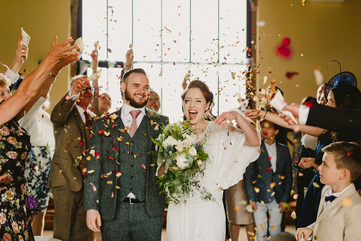 Alice wears a Downton Abbey inspired beaded gown by Eliza Jane Howell for her Suffolk countryside wedding. Photography by Andy Davison.