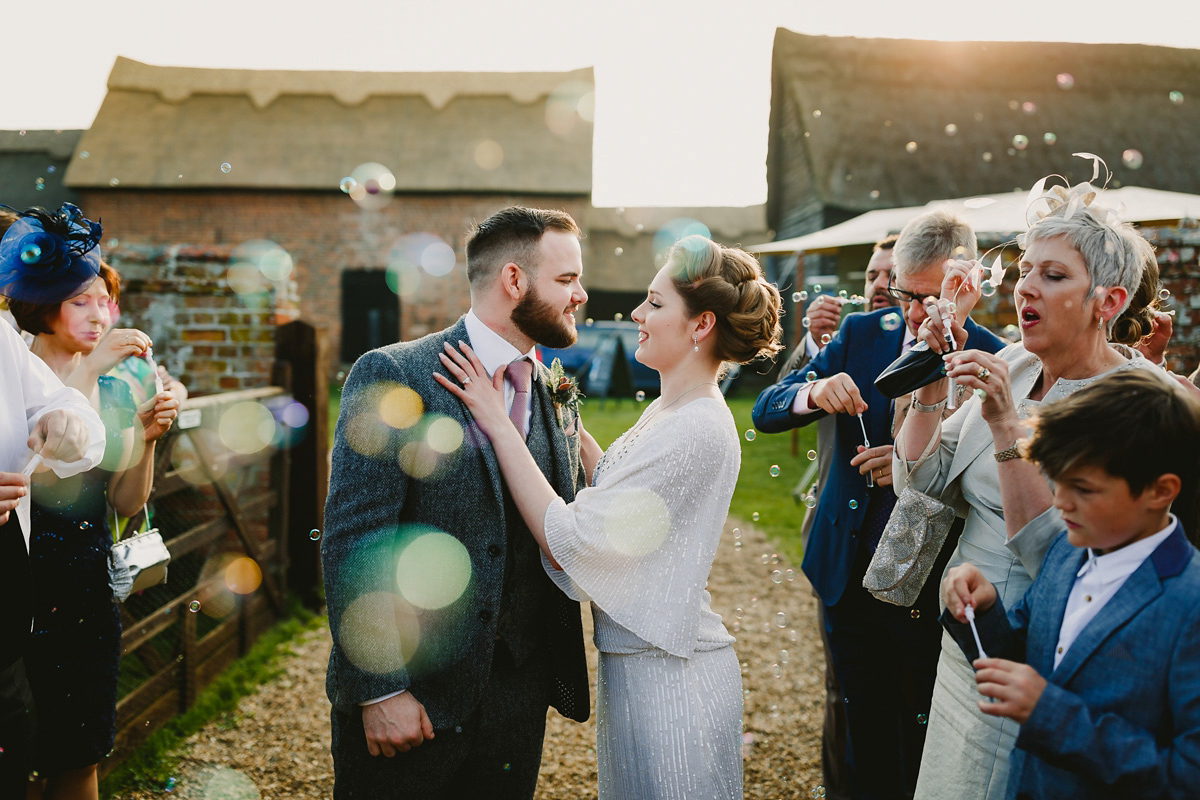 Alice wears a Downton Abbey inspired beaded gown by Eliza Jane Howell for her Suffolk countryside wedding. Photography by Andy Davison.