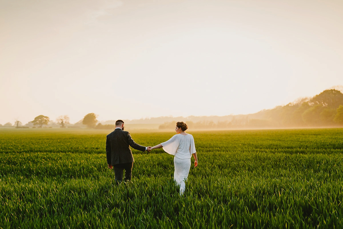 Alice wears a Downton Abbey inspired beaded gown by Eliza Jane Howell for her Suffolk countryside wedding. Photography by Andy Davison.