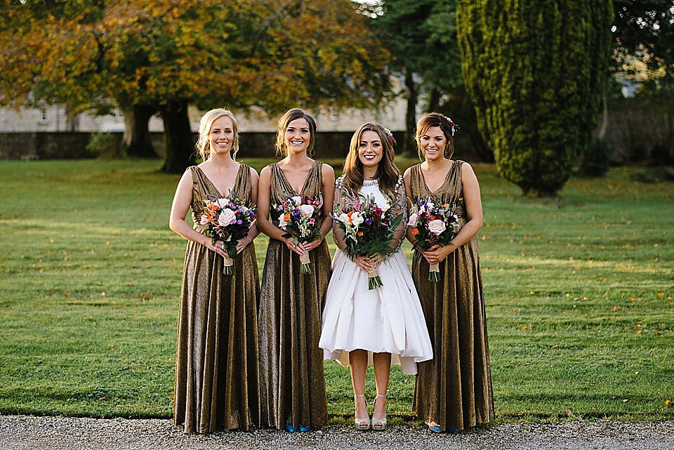 Karen wore a wedding dress with epaulettes for her Irish castle wedding in the Autumn. Photography by Epic Love.