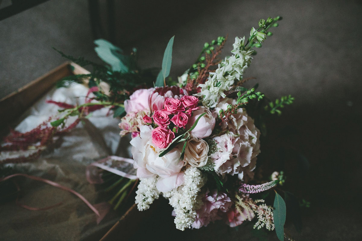 A floral wedding dress by Sassi Holford for a Summer wedding in the Peak District. Flowers by Campbell's Flowers, photography by Ellie Grace.