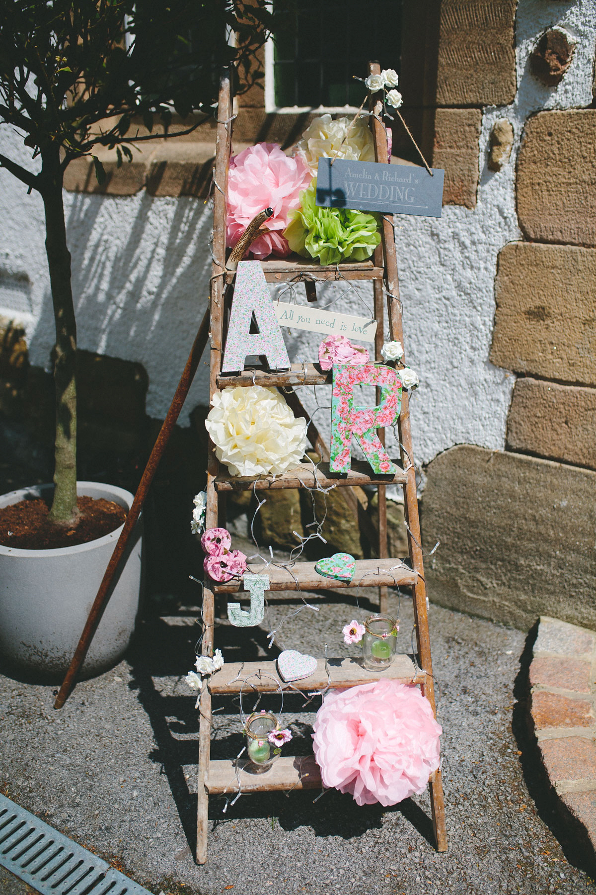 A floral wedding dress by Sassi Holford for a Summer wedding in the Peak District. Flowers by Campbell's Flowers, photography by Ellie Grace.