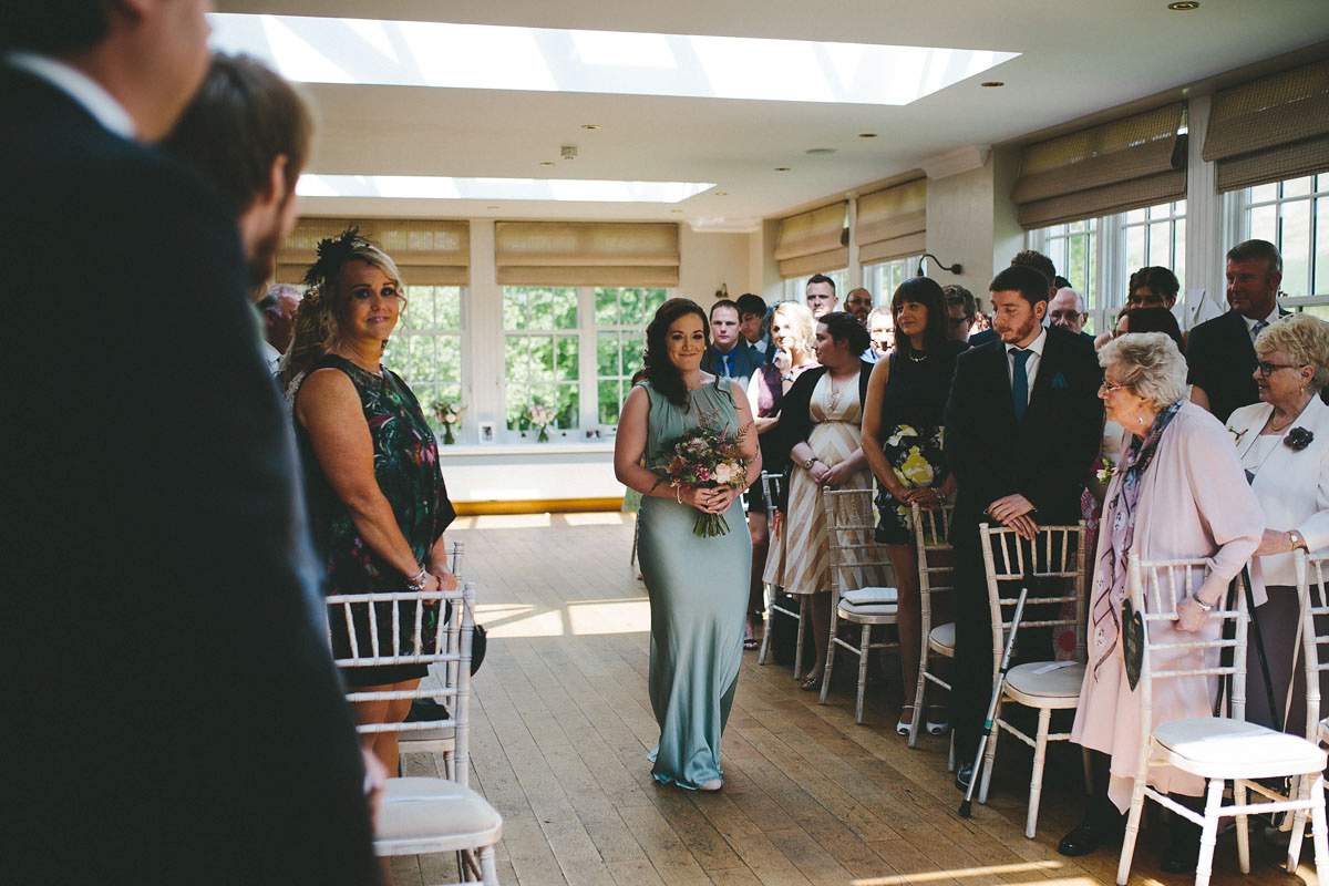 A floral wedding dress by Sassi Holford for a Summer wedding in the Peak District. Flowers by Campbell's Flowers, photography by Ellie Grace.