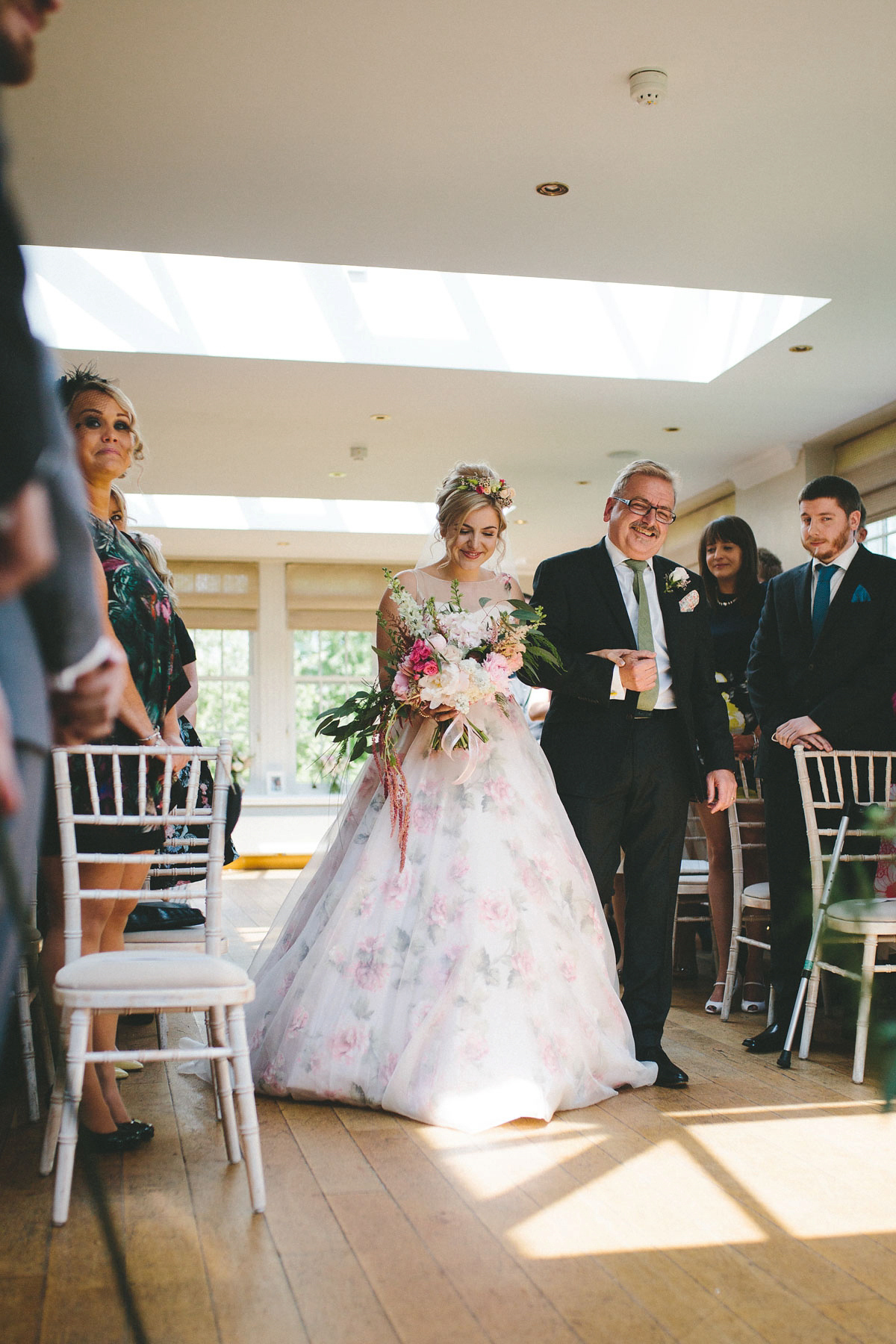 A floral wedding dress by Sassi Holford for a Summer wedding in the Peak District. Flowers by Campbell's Flowers, photography by Ellie Grace.