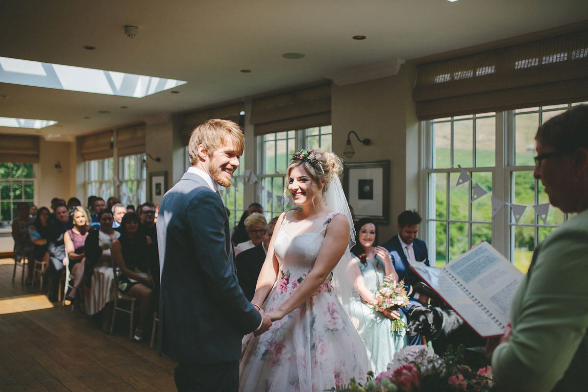 A floral wedding dress by Sassi Holford for a Summer wedding in the Peak District. Flowers by Campbell's Flowers, photography by Ellie Grace.