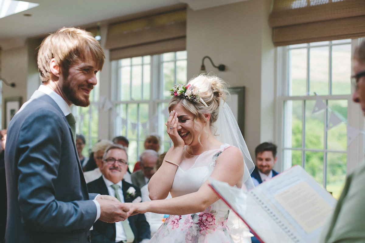 A floral wedding dress by Sassi Holford for a Summer wedding in the Peak District. Flowers by Campbell's Flowers, photography by Ellie Grace.