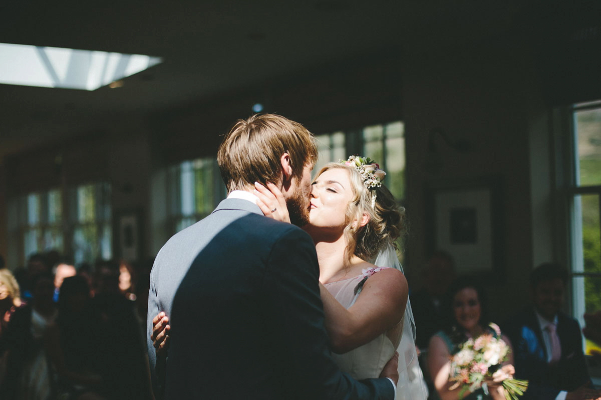 A floral wedding dress by Sassi Holford for a Summer wedding in the Peak District. Flowers by Campbell's Flowers, photography by Ellie Grace.