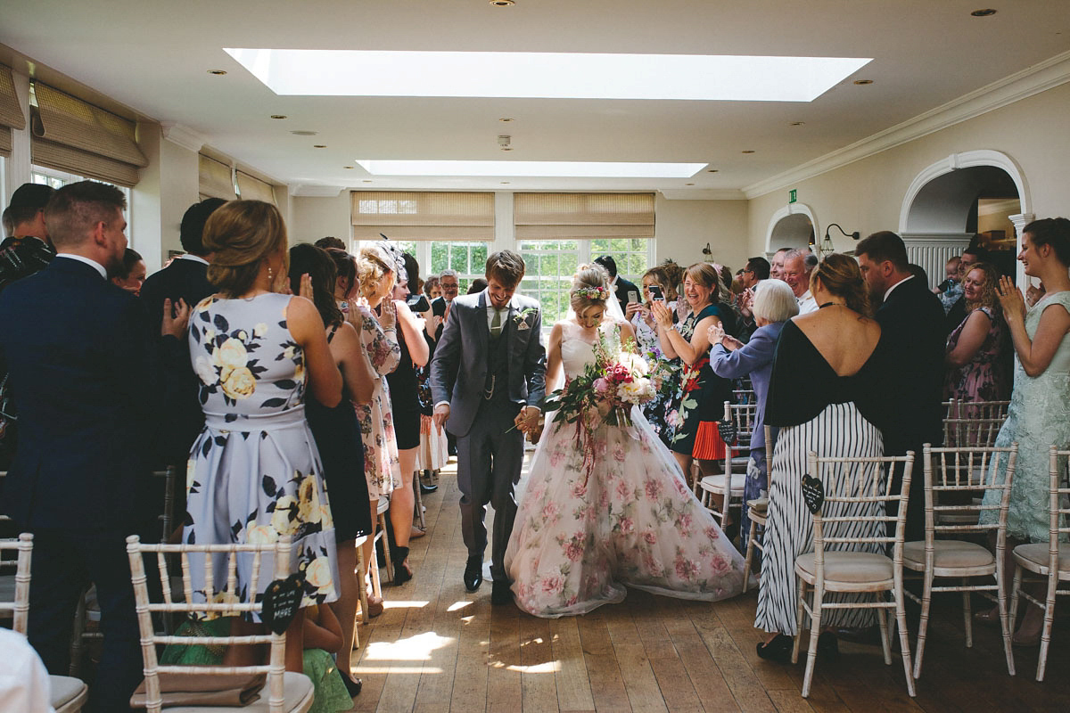 A floral wedding dress by Sassi Holford for a Summer wedding in the Peak District. Flowers by Campbell's Flowers, photography by Ellie Grace.