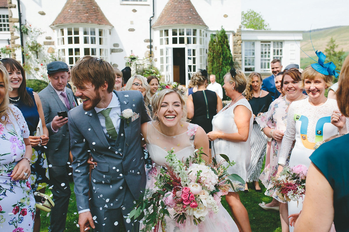 A floral wedding dress by Sassi Holford for a Summer wedding in the Peak District. Flowers by Campbell's Flowers, photography by Ellie Grace.