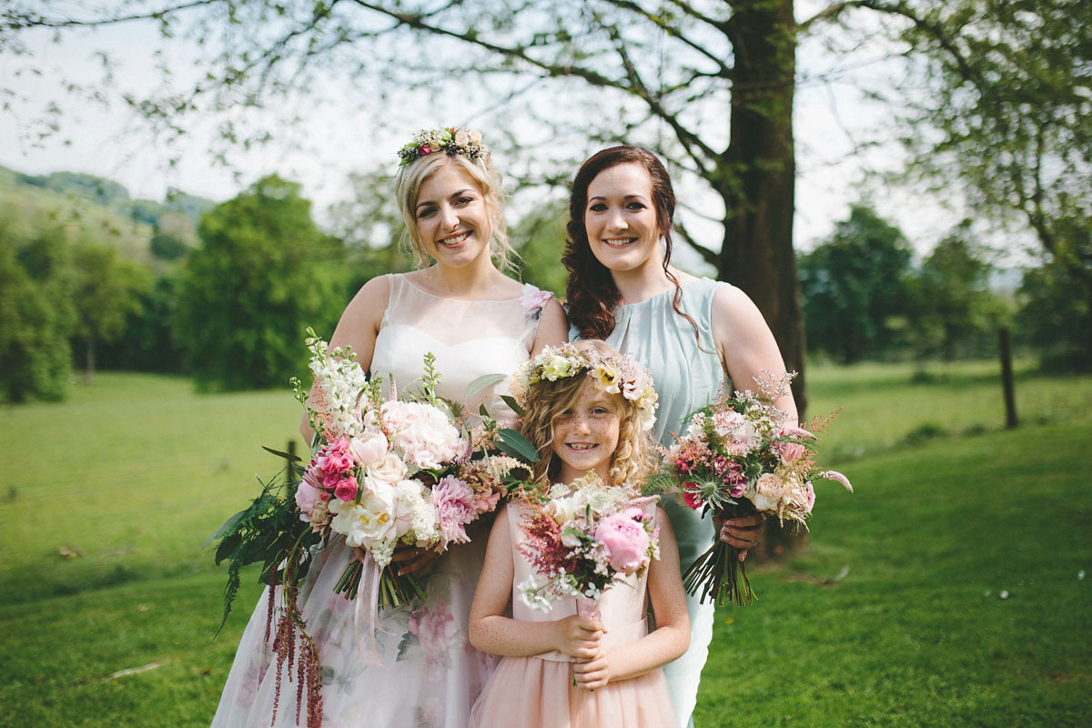 A floral wedding dress by Sassi Holford for a Summer wedding in the Peak District. Flowers by Campbell's Flowers, photography by Ellie Grace.