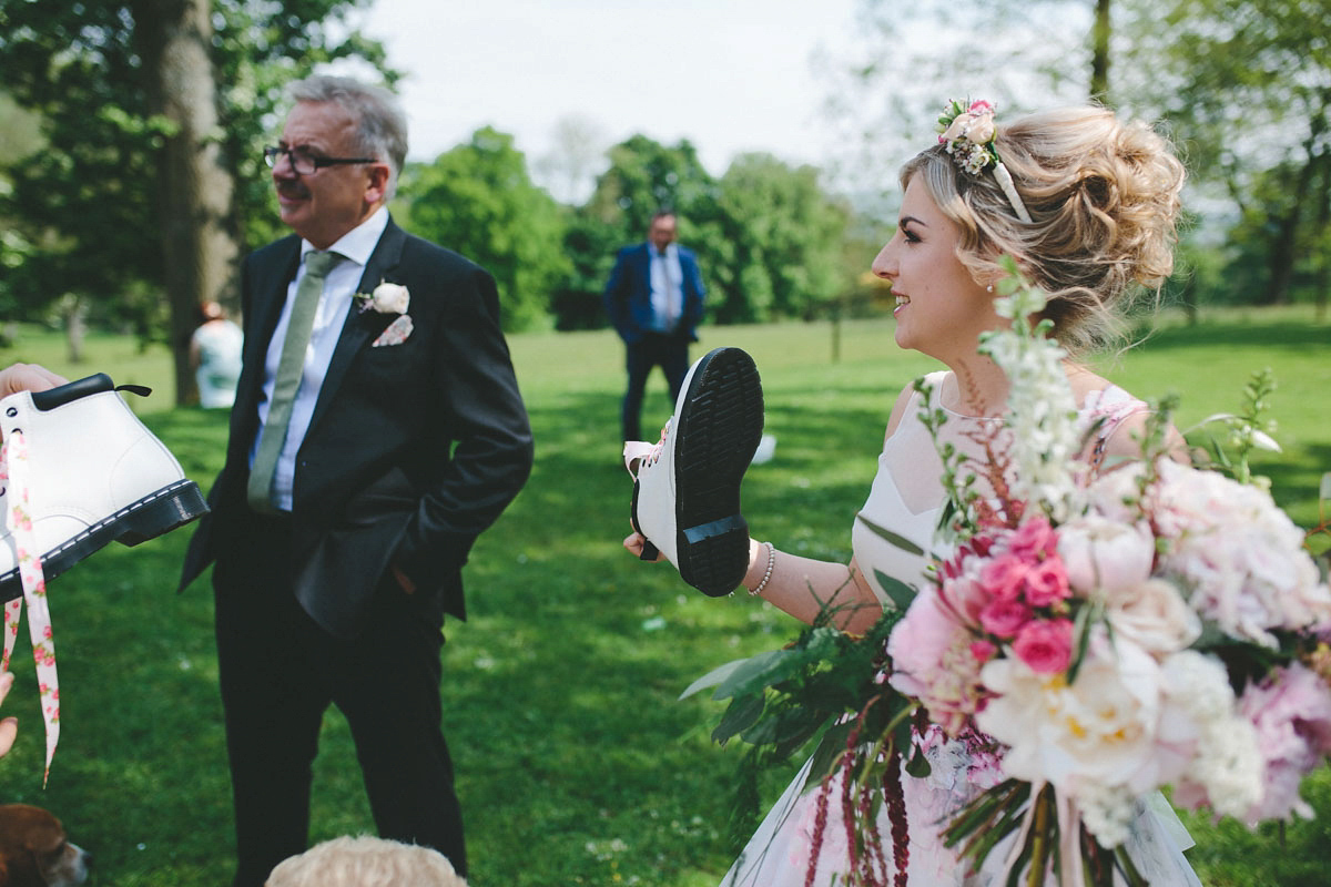 A floral wedding dress by Sassi Holford for a Summer wedding in the Peak District. Flowers by Campbell's Flowers, photography by Ellie Grace.