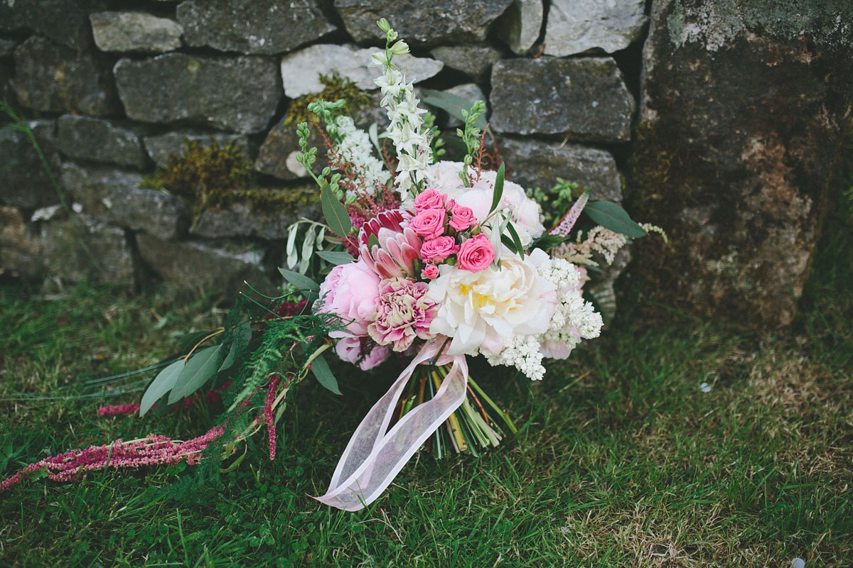 A floral wedding dress by Sassi Holford for a Summer wedding in the Peak District. Flowers by Campbell's Flowers, photography by Ellie Grace.