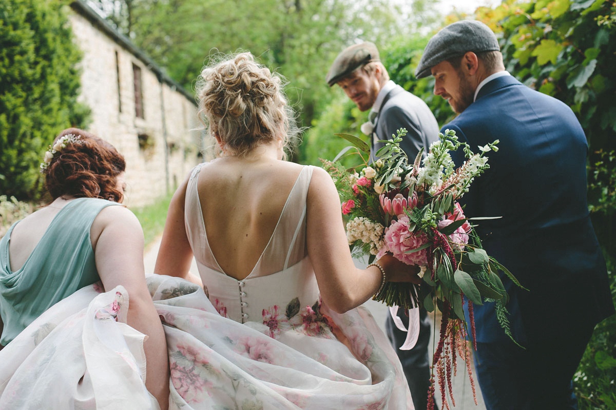 A floral wedding dress by Sassi Holford for a Summer wedding in the Peak District. Flowers by Campbell's Flowers, photography by Ellie Grace.