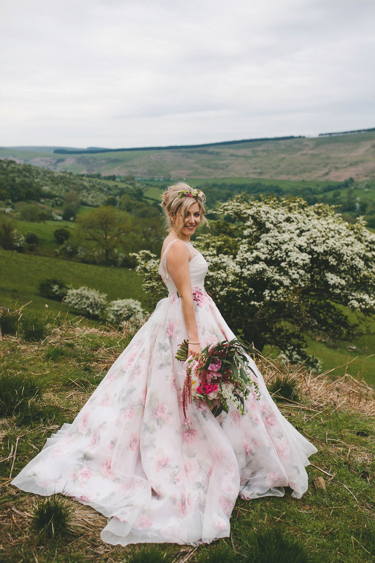 A floral wedding dress by Sassi Holford for a Summer wedding in the Peak District. Flowers by Campbell's Flowers, photography by Ellie Grace.