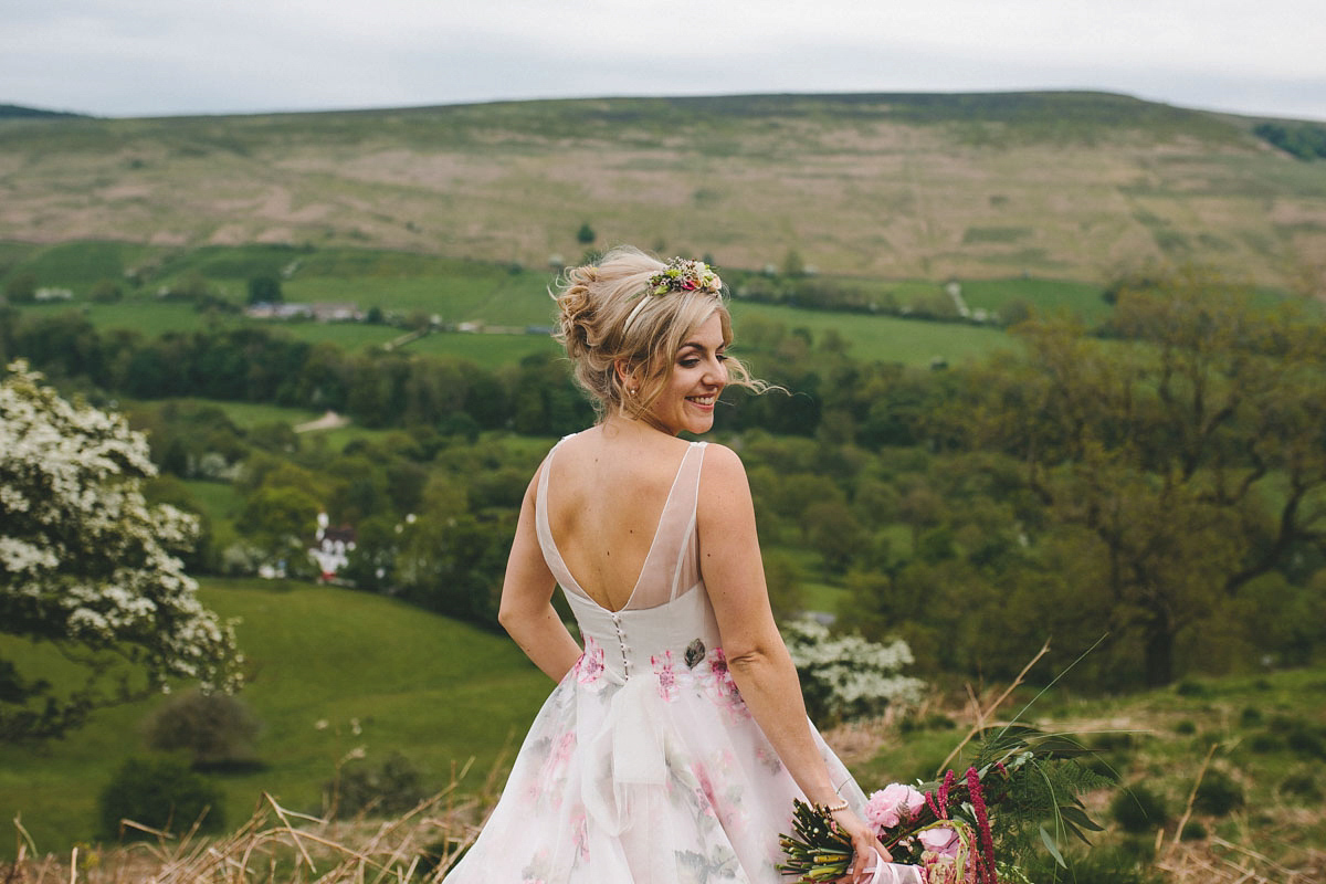 A floral wedding dress by Sassi Holford for a Summer wedding in the Peak District. Flowers by Campbell's Flowers, photography by Ellie Grace.