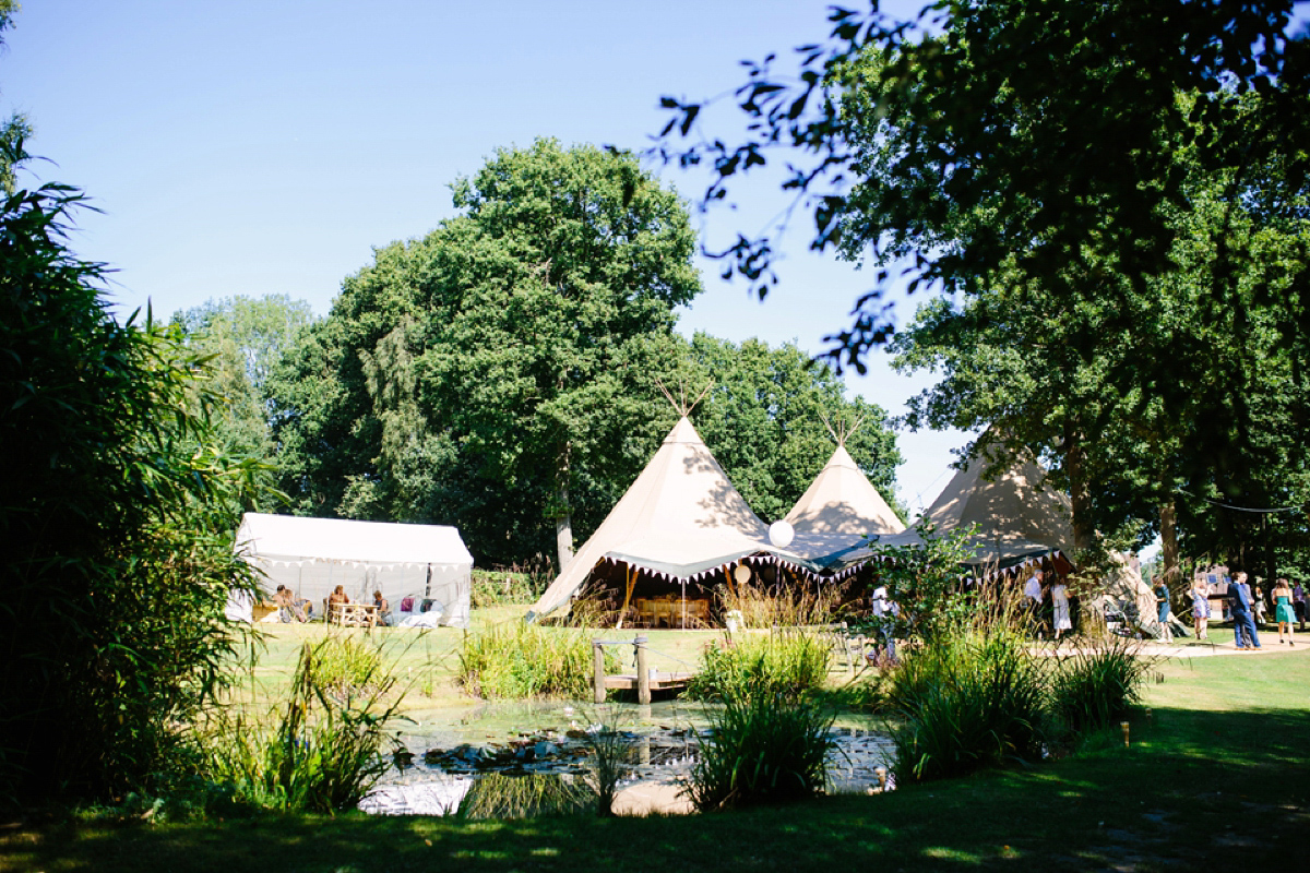 Hollie wore a Lusan Mandongus gown for her tipi wedding set in the Sussex countryside. Photography by Hayley Savage.