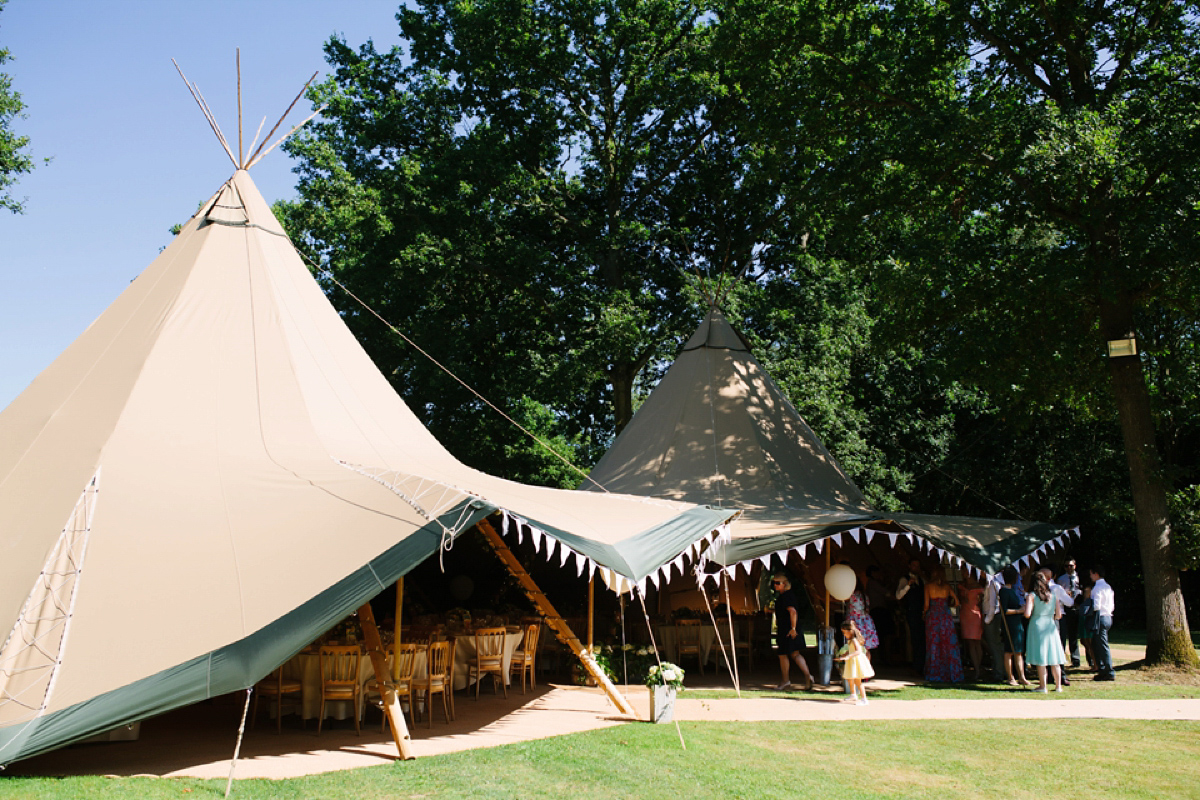 Hollie wore a Lusan Mandongus gown for her tipi wedding set in the Sussex countryside. Photography by Hayley Savage.