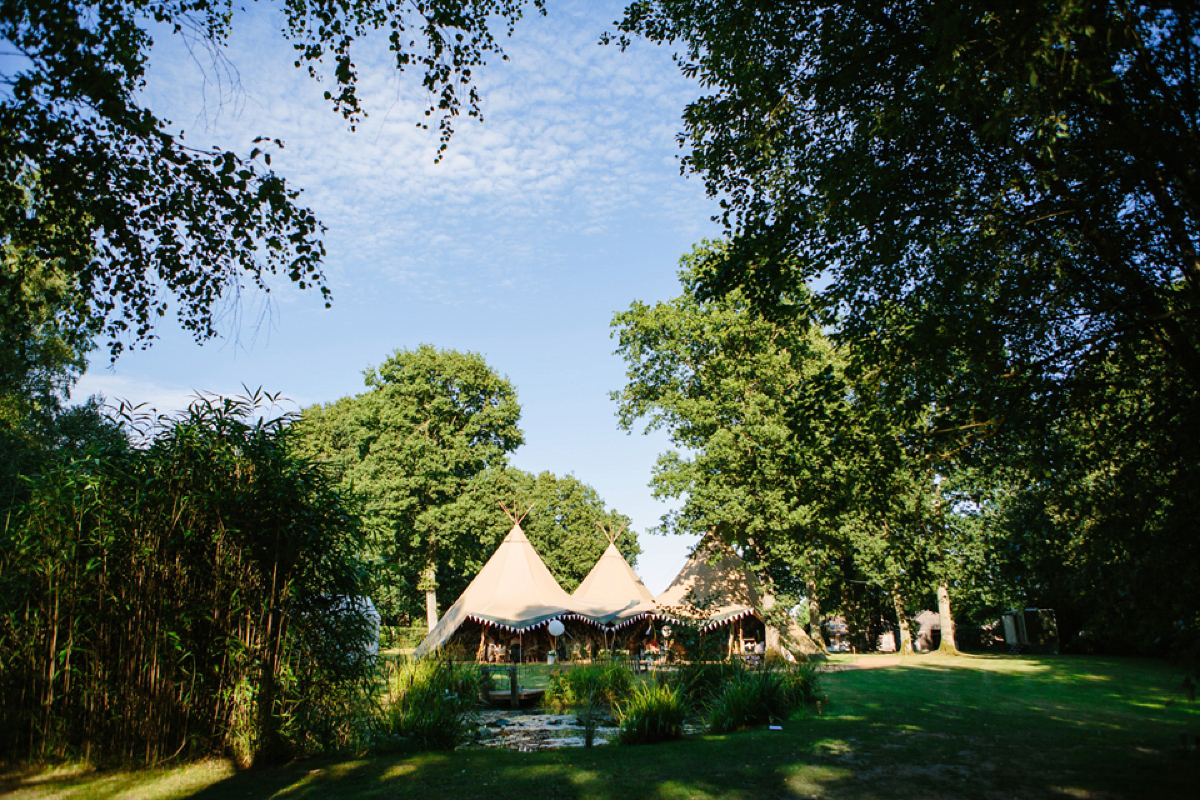 Hollie wore a Lusan Mandongus gown for her tipi wedding set in the Sussex countryside. Photography by Hayley Savage.