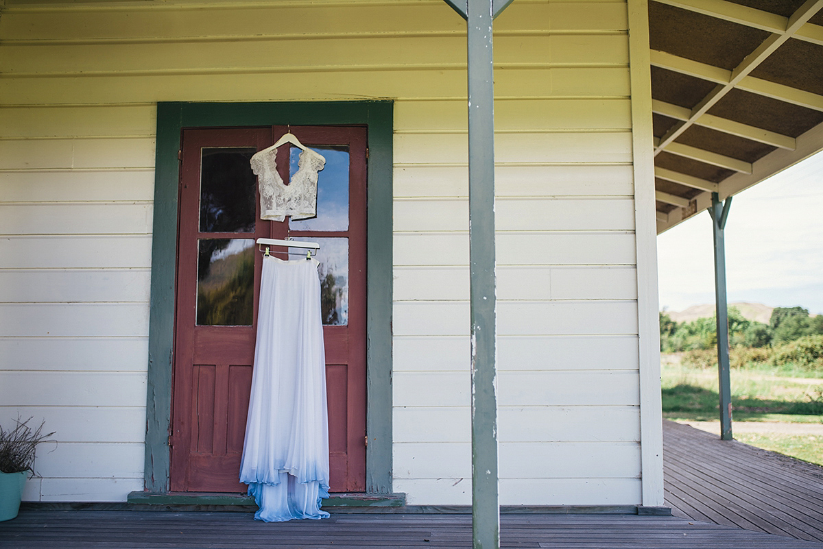 Suzy wore a stunning ombre/dip dye dress for her barefoot beach wedding in New Zealand. Photography by Meredith Lord.