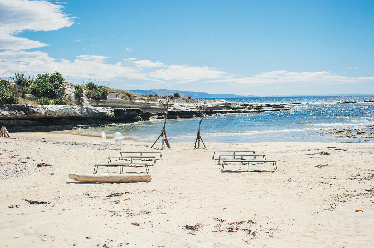 Suzy wore a stunning ombre/dip dye dress for her barefoot beach wedding in New Zealand. Photography by Meredith Lord.